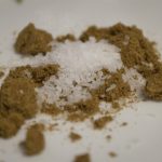 Salt and cumin sitting on a plate.